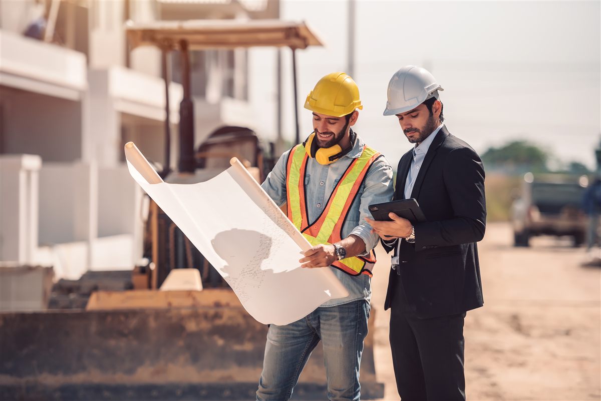 Construction team reviewing plans on site
